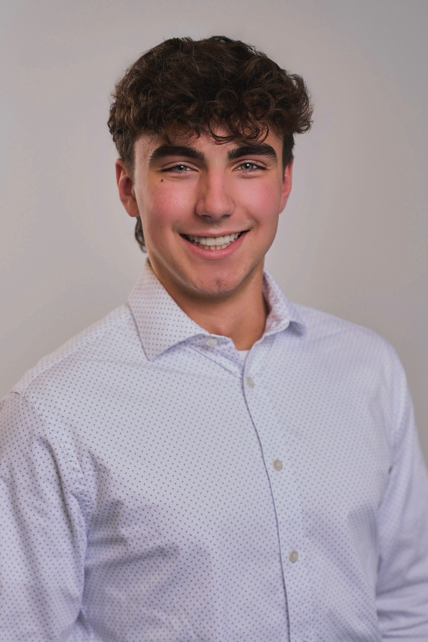Jacob Tartabini portrait, white button-down shirt, neutral background